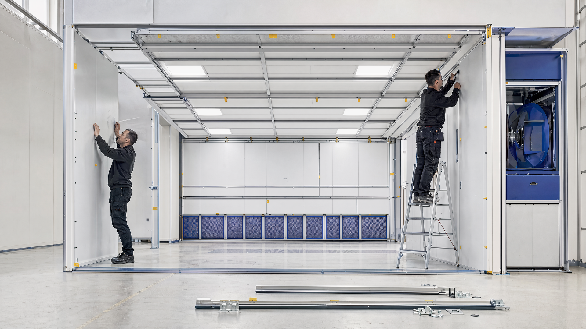 Representative local team assembling modular spray-booth panels